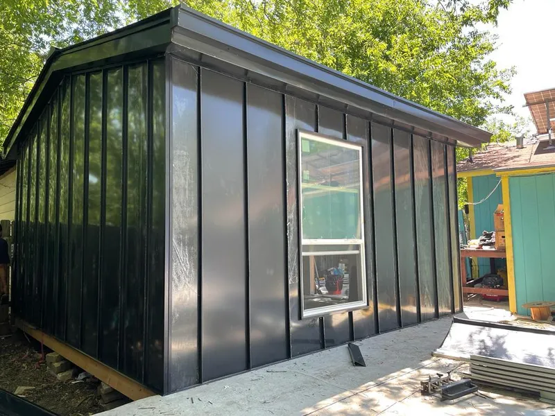 Black standing seam metal wall panels for Roof Inspection in Hope Mills