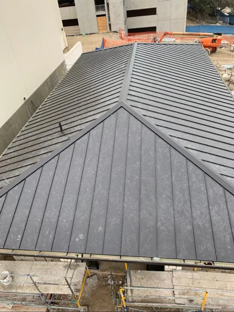 Commercial metal roof construction with crane equipment in Hope Mills